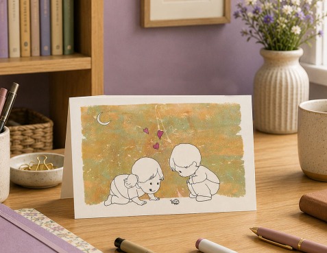A Little Puff greeting card on a desk